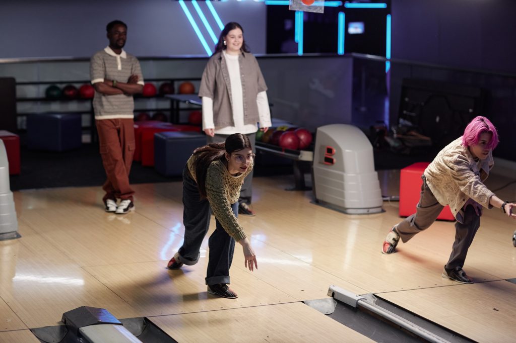 Friends Enjoying Indoor Bowling Activity