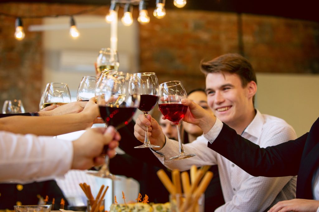 Happy co-workers celebrating while company party and corporate event